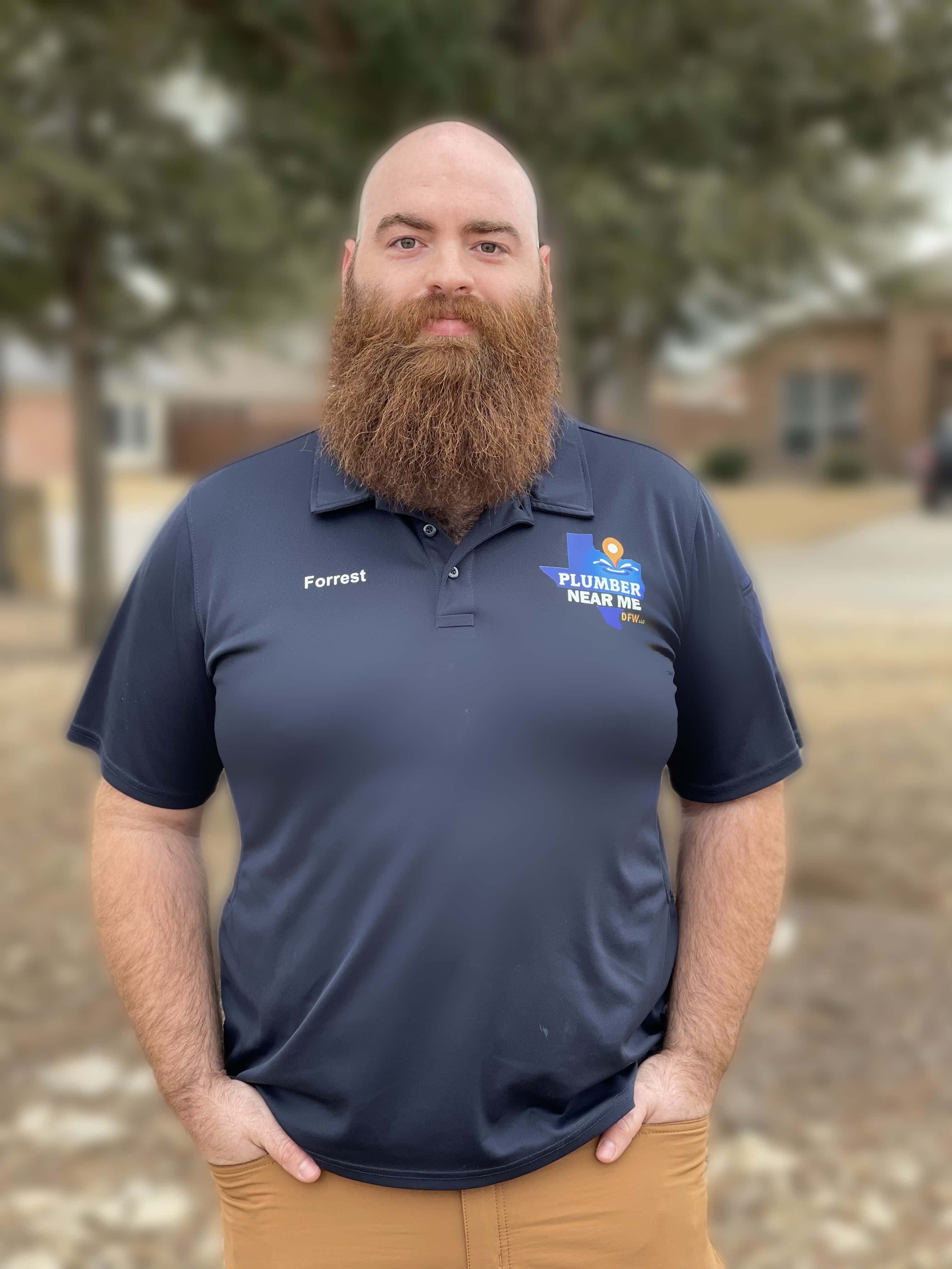 Plumber Near Me DFW team member in branded polo shirt, standing outdoors, showcasing expertise in plumbing services for Flower Mound, Lewisville and Watauga, TX.